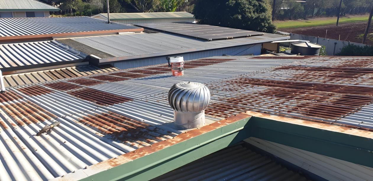 Rusty Roof With a Wind Turbine — Steve Oberhardt Roof Restorations & Repairs in Westbrook, QLD
