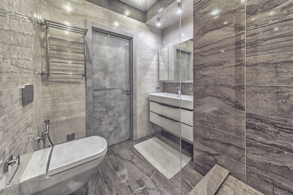 Modern Bathroom With Grey and White Tile, Toilet, Sink, Mirror, and Shower — Morrison Cabinetry in Cedar Pocket, QLD