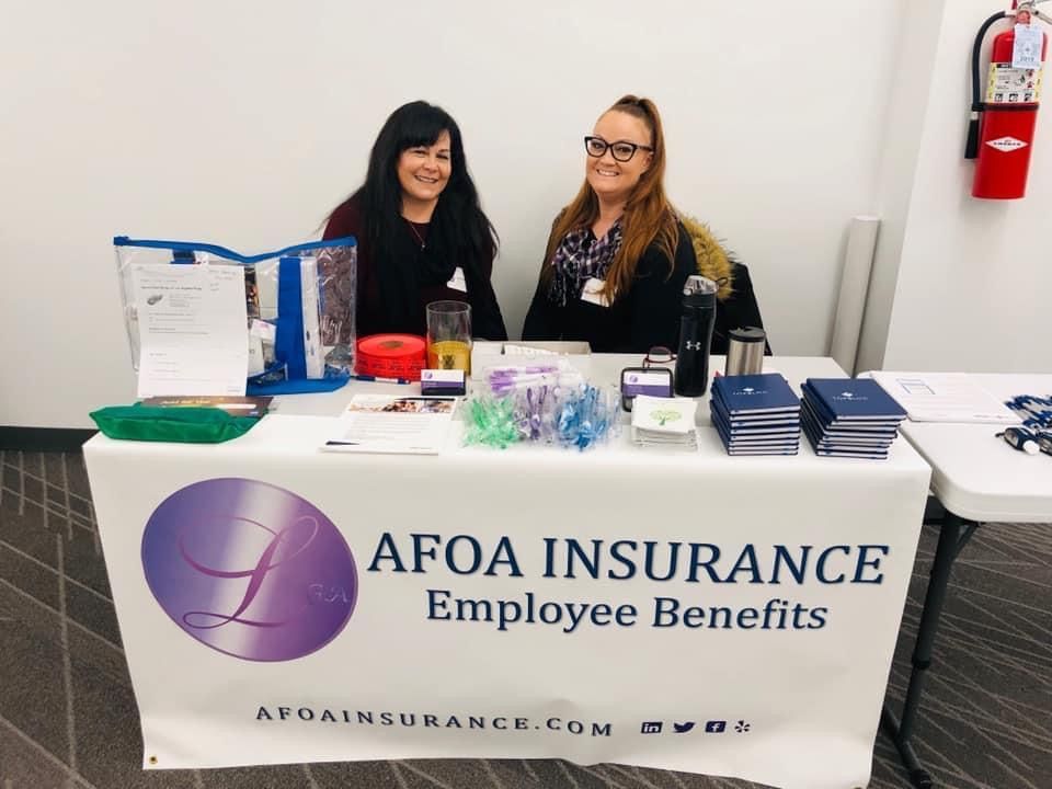 AFOA Insurance Employee Benefits booth with two women behind a table and promotional materials