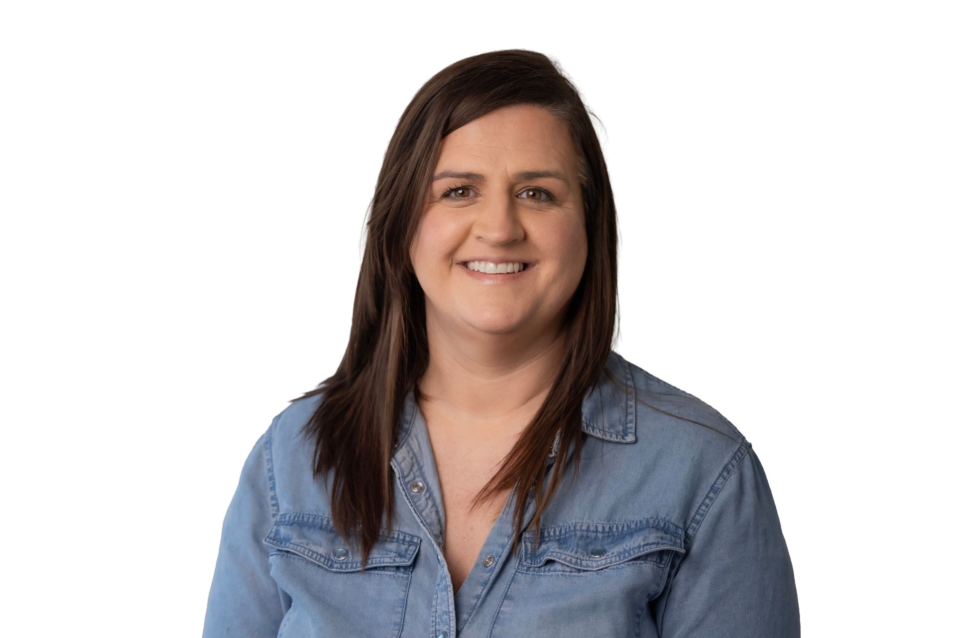 Smiling person with long dark hair wearing a blue denim shirt against a white background