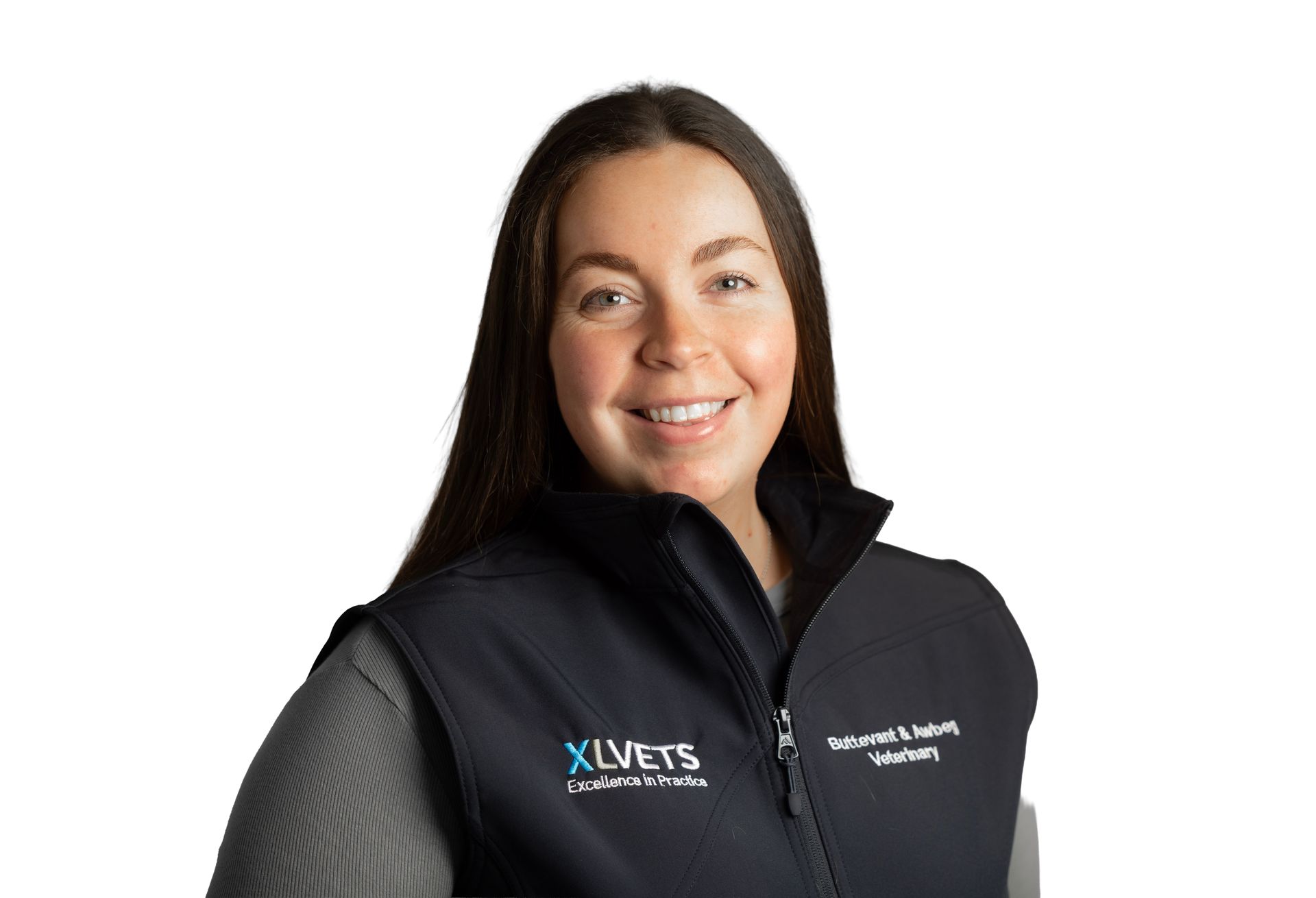 Woman in a black zip-up vest smiling against a white background