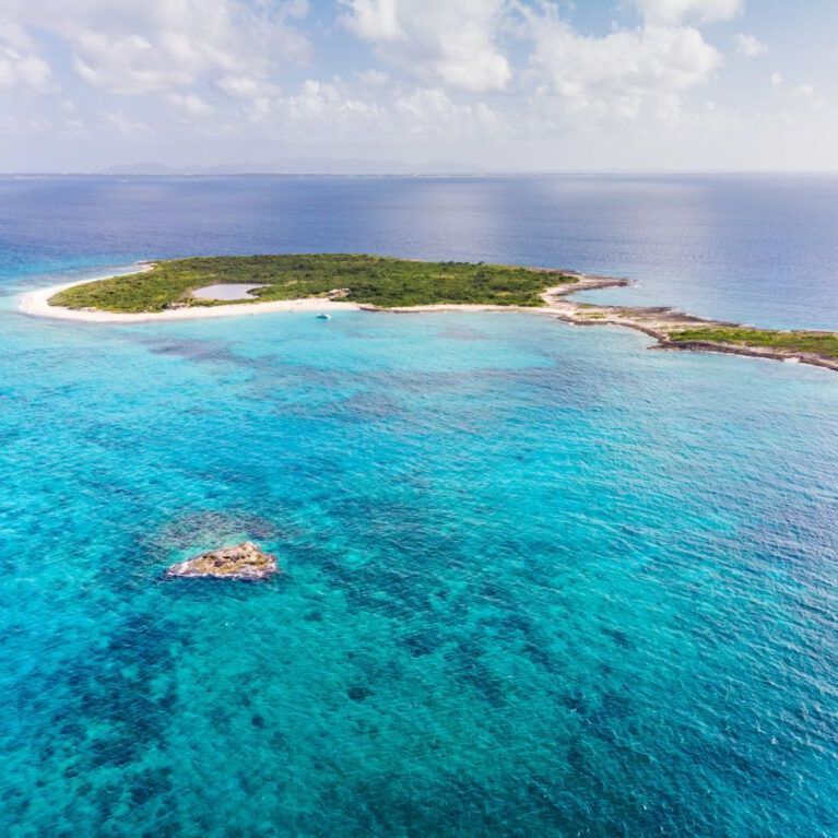 Prickly Pear photo by drone with crystal clear water, accessible by arawak charters destination inear Anguilla