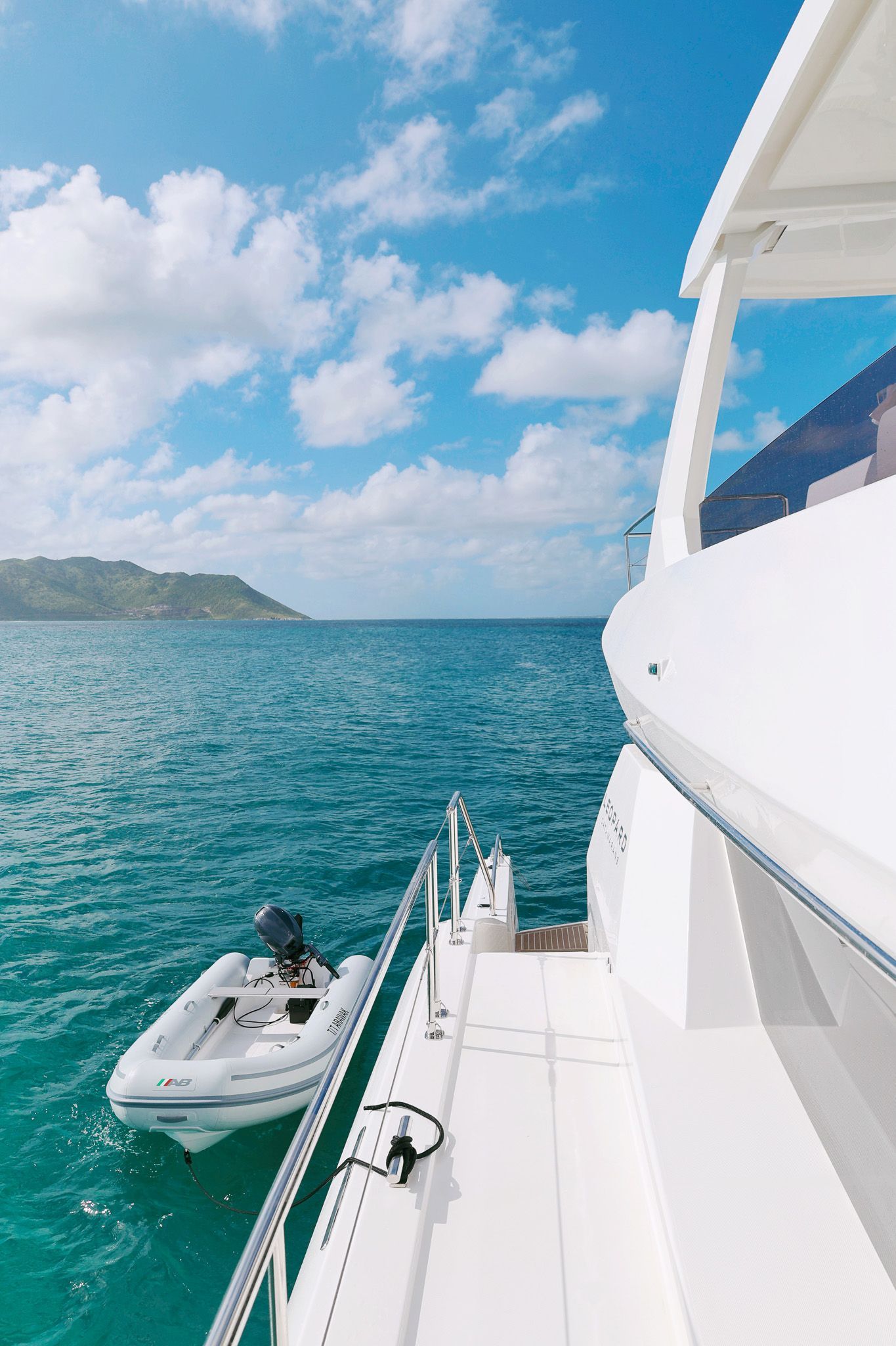 Leopard 53 Power Catamaran by Arawak Charters cruising through turquoise waters of the Caribbean.