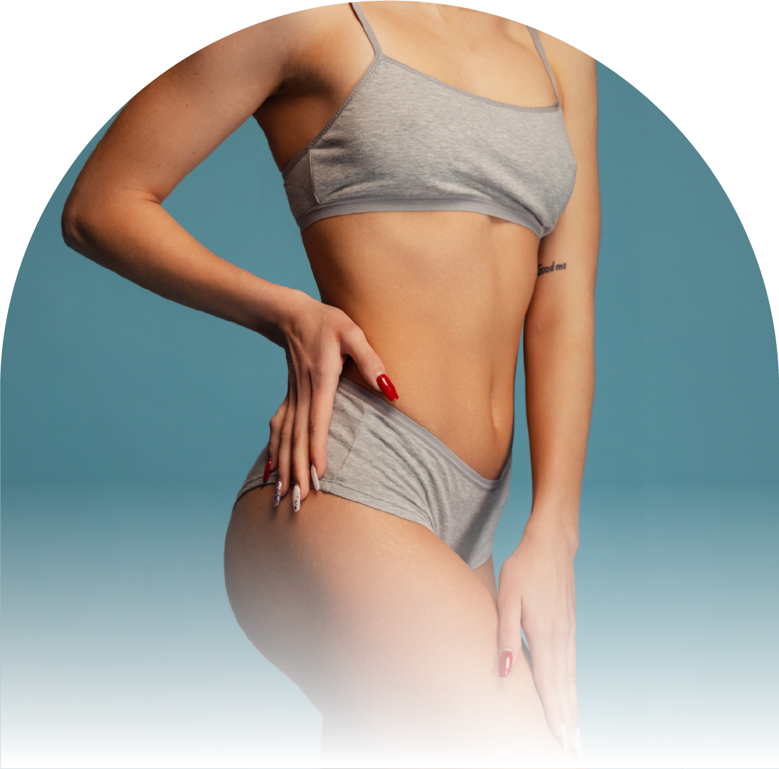 A woman in a bikini top and shorts is standing with her hands on her hips.