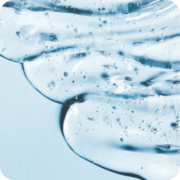 A close up of a blue gel with bubbles on a blue surface.