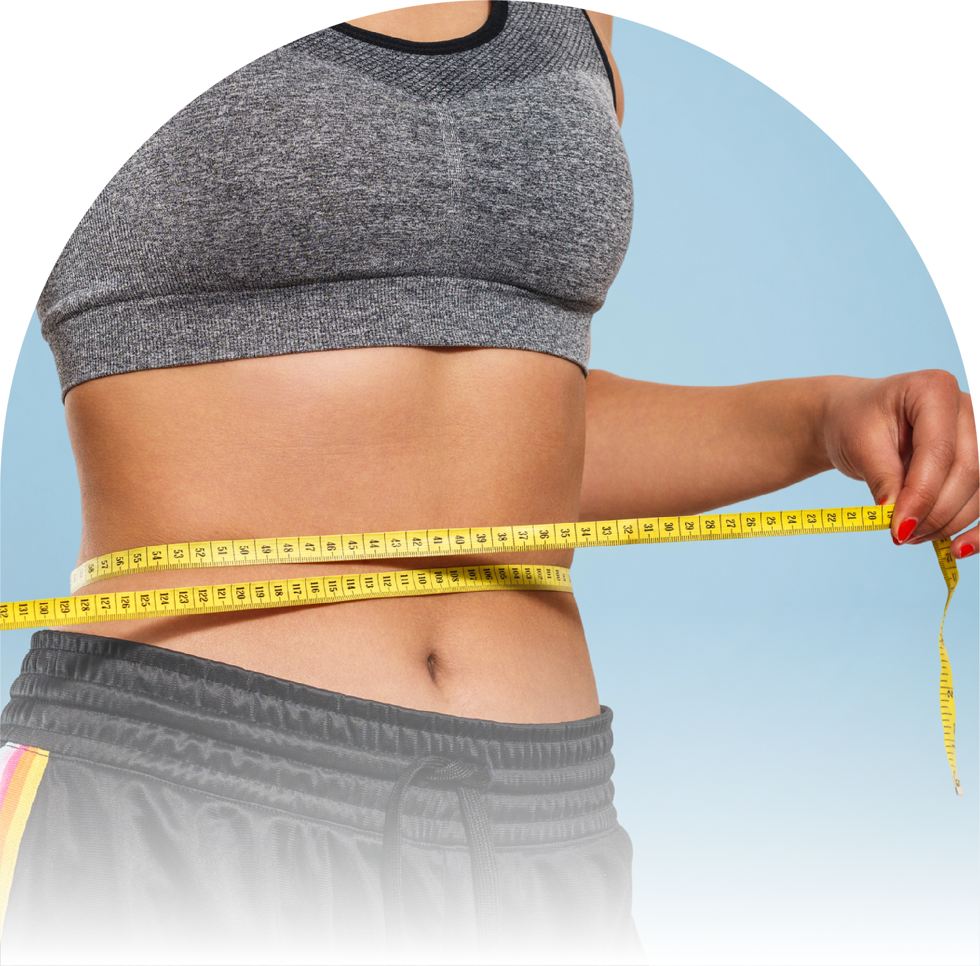 Medical wight loss management at Holos Medical Spa. A woman measures her waist.