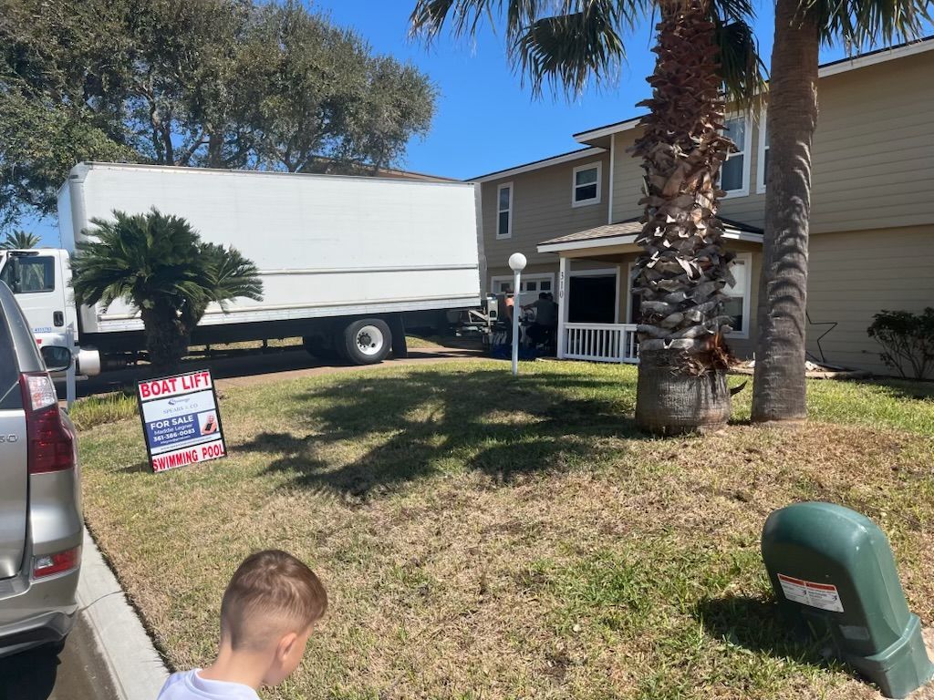 Moving truck in front of a house with a 