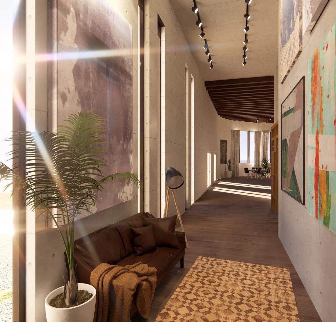 A long hallway with a couch and paintings on the wall