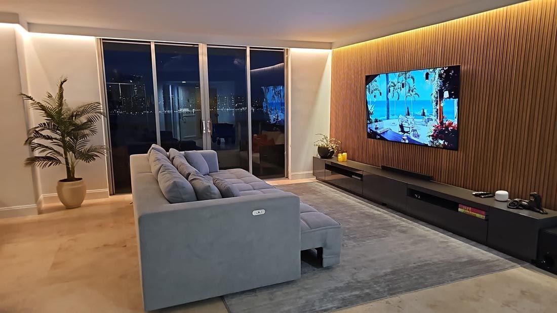 A living room with a couch and a flat screen tv.