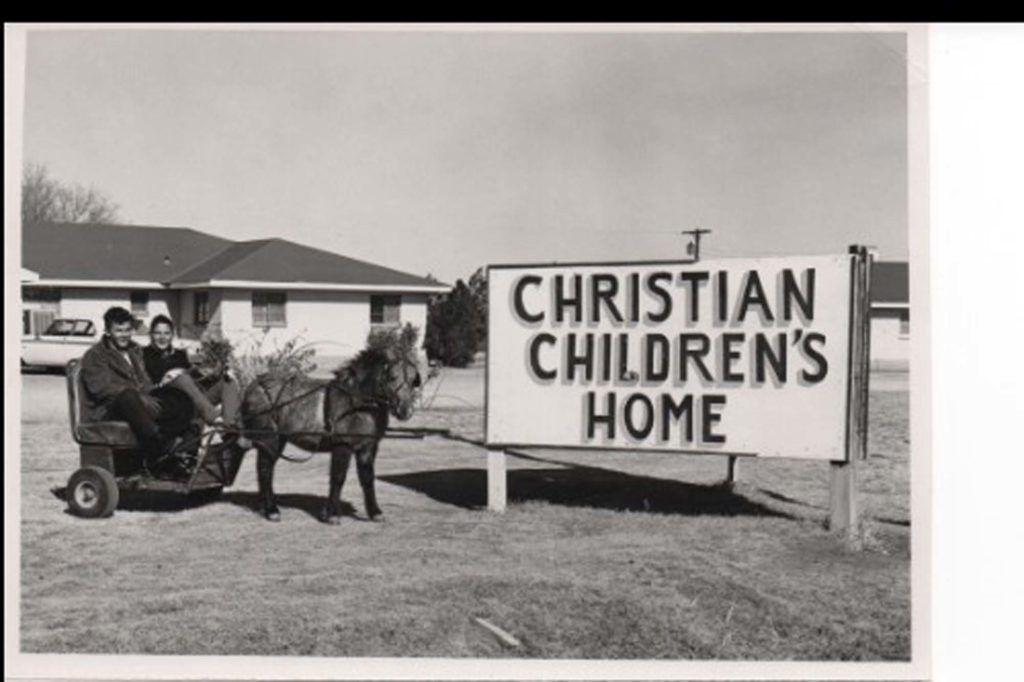 A black and white photo of a christian children 's home