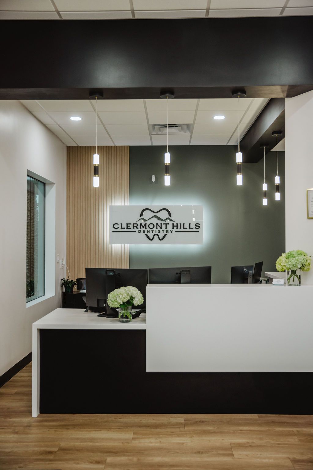 Modern dental office reception desk with sign