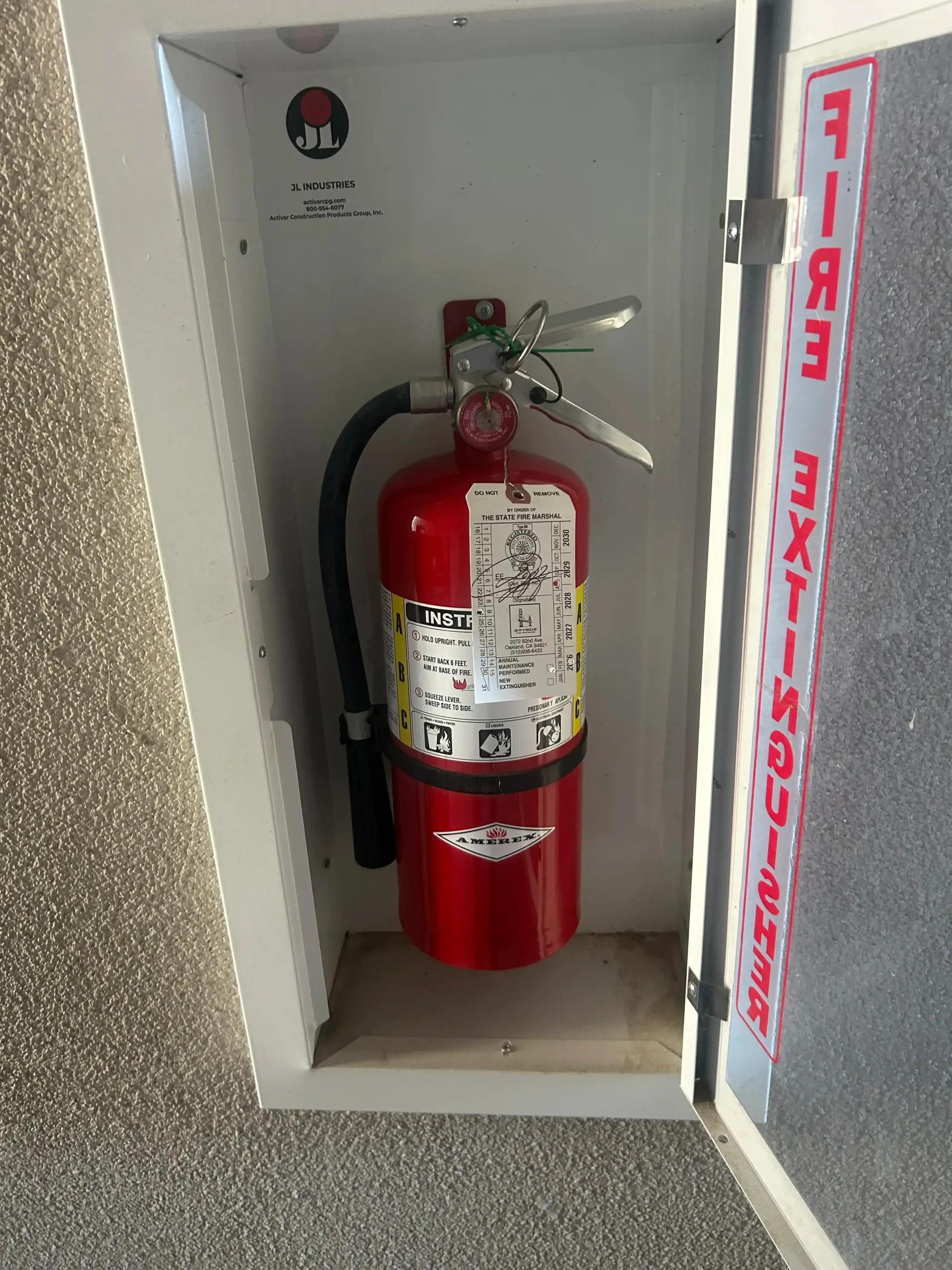 Tagged fire extinguisher in a wall cabinet