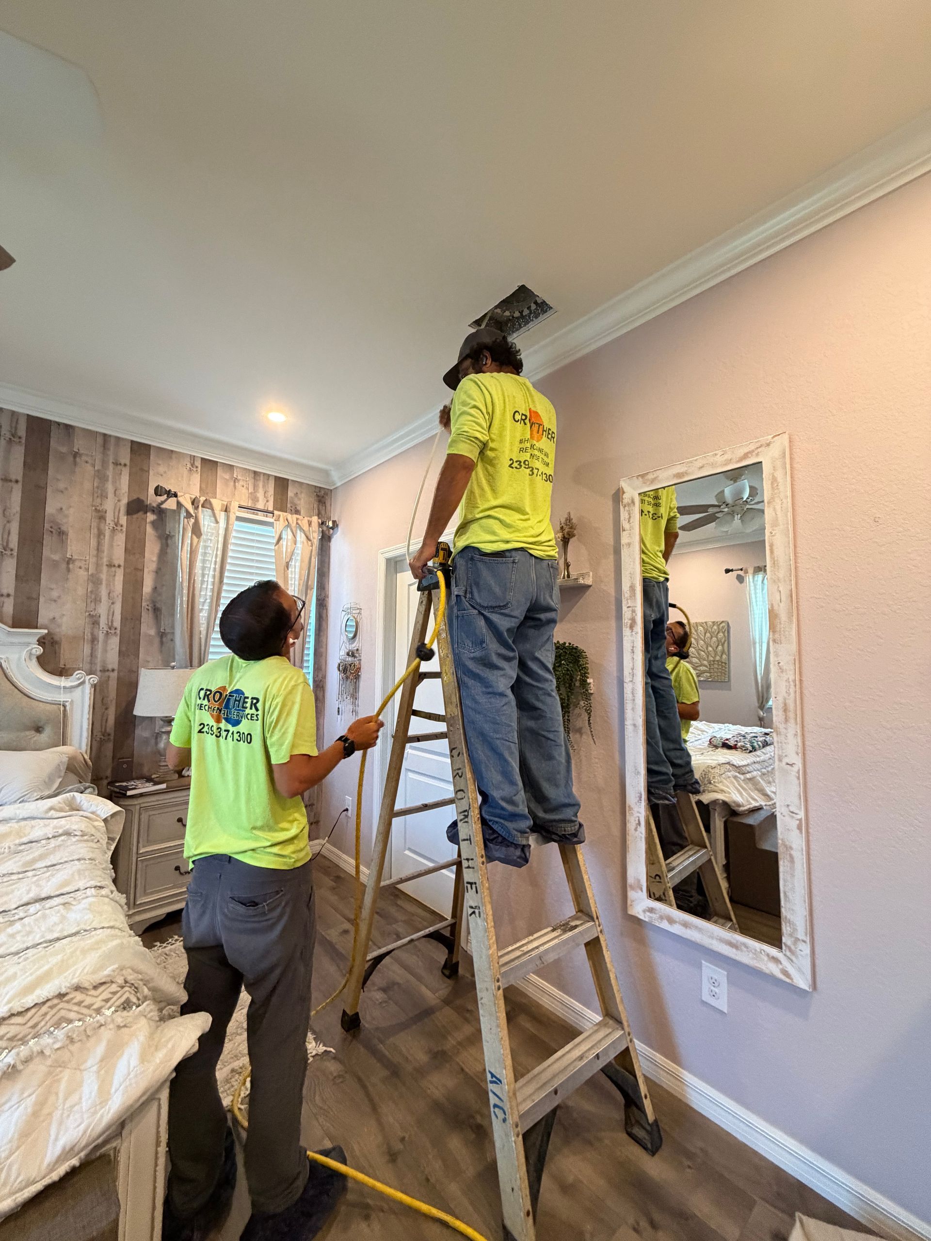 Fort Myers homeowner adjusting a thermostat after an air conditioner replacement