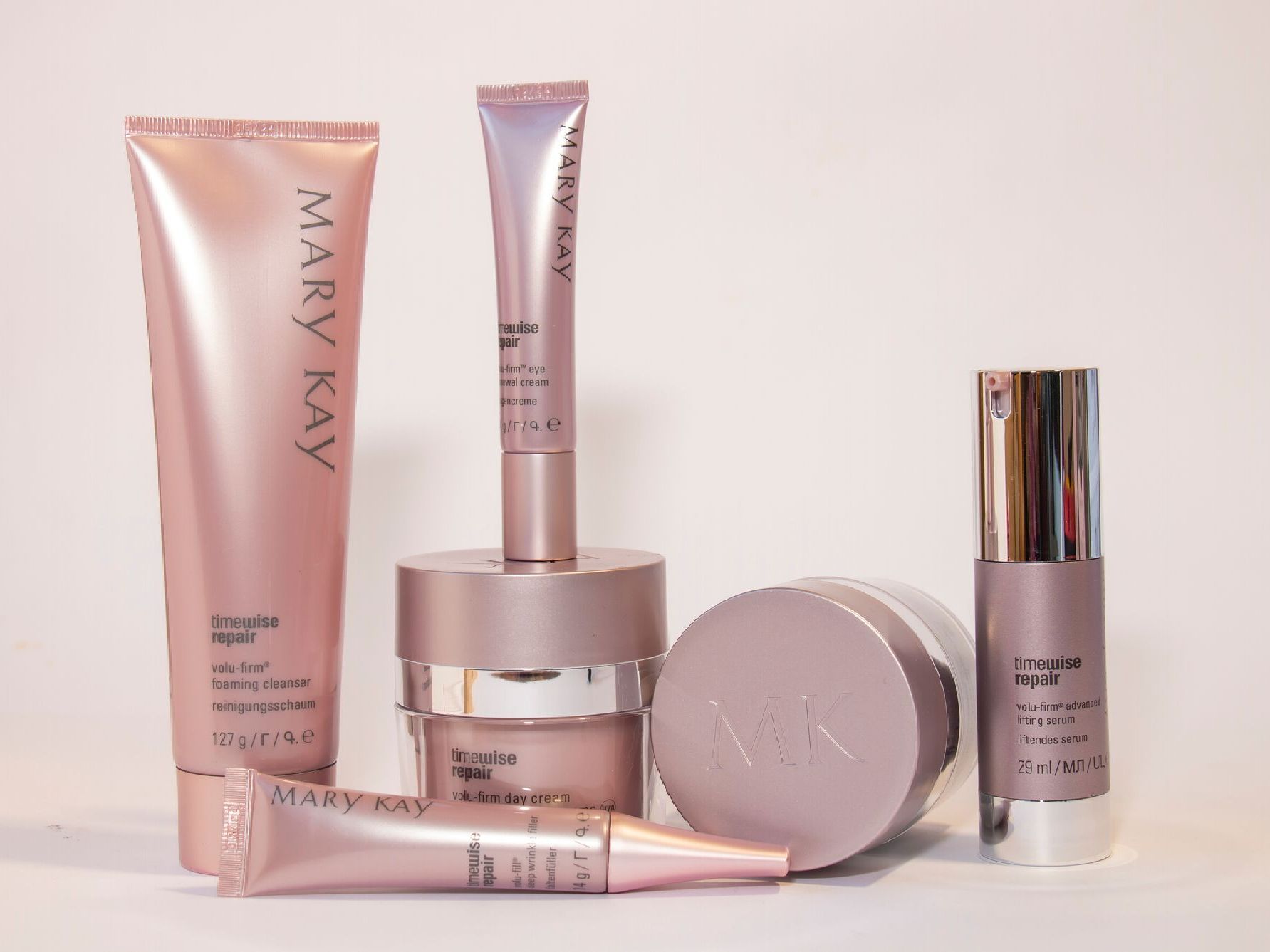 A group of mary kay products are lined up on a table