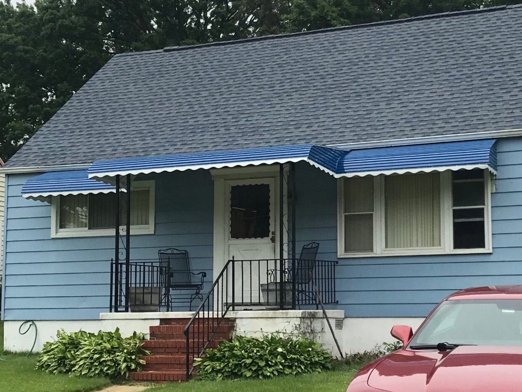 Long blue metal awning for a front door in Maryland