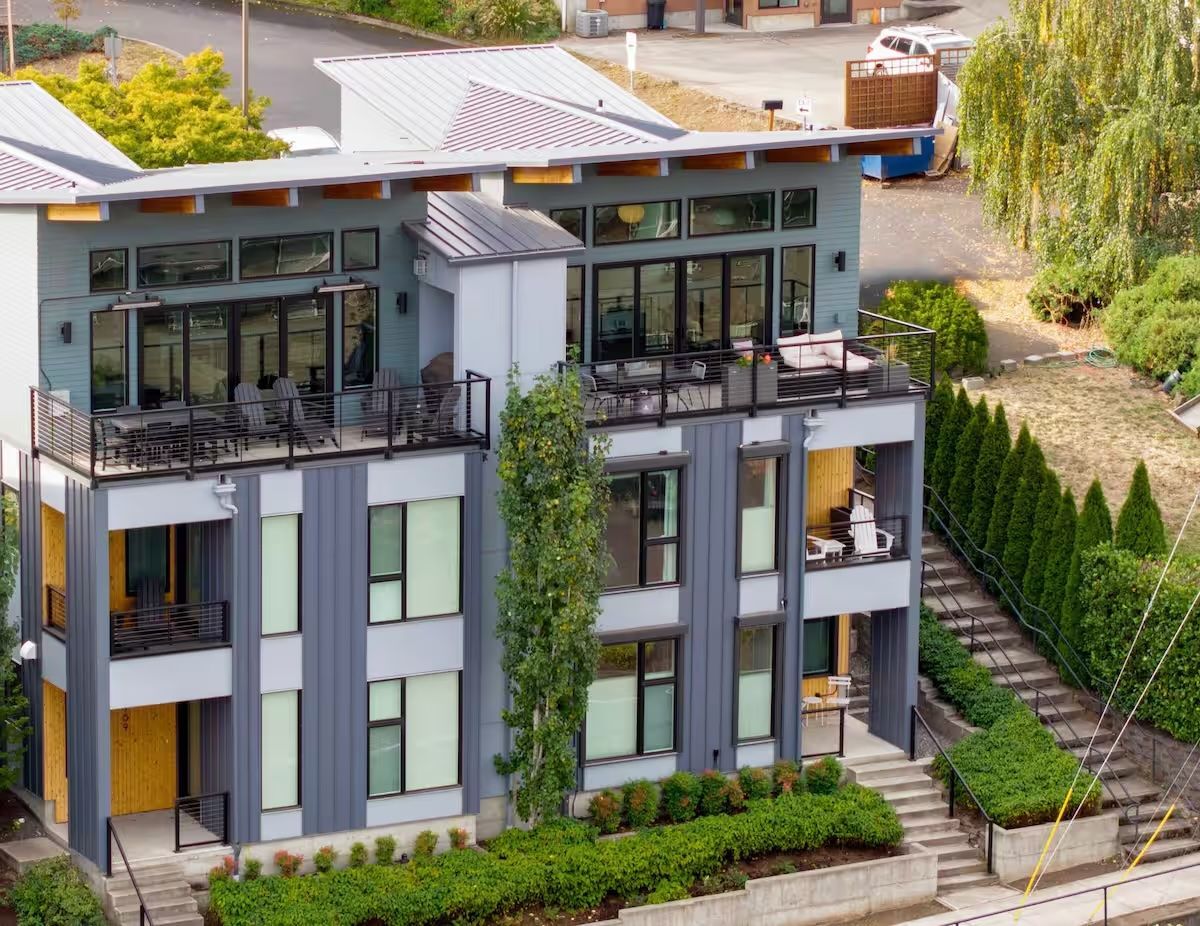 An aerial view of a large apartment building with stairs leading up to it