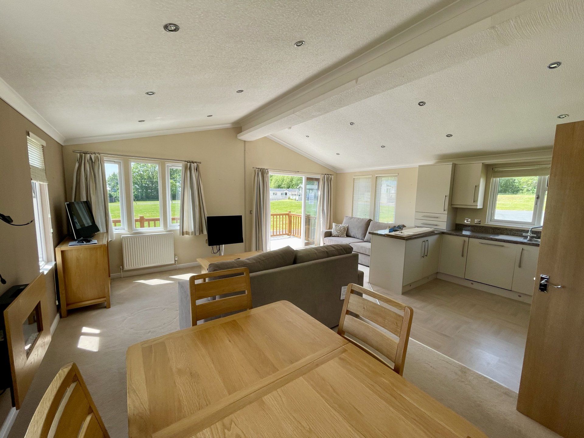 A living room with a dining table and chairs and a kitchen