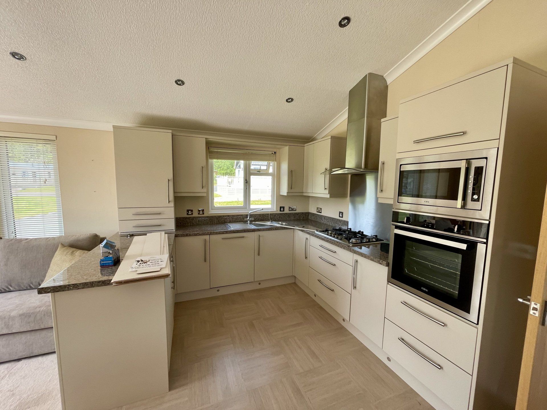 A kitchen with white cabinets and stainless steel appliances