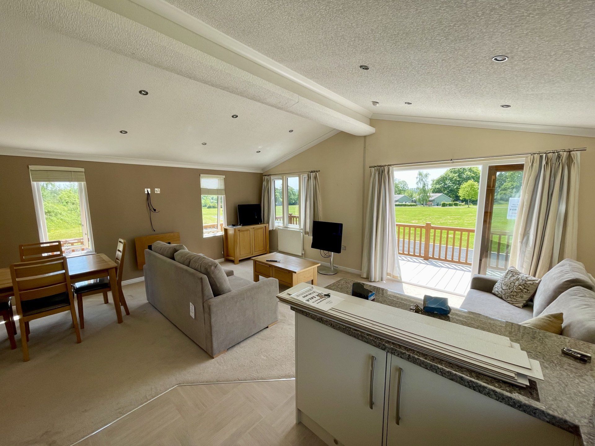A living room with a couch , table and chairs