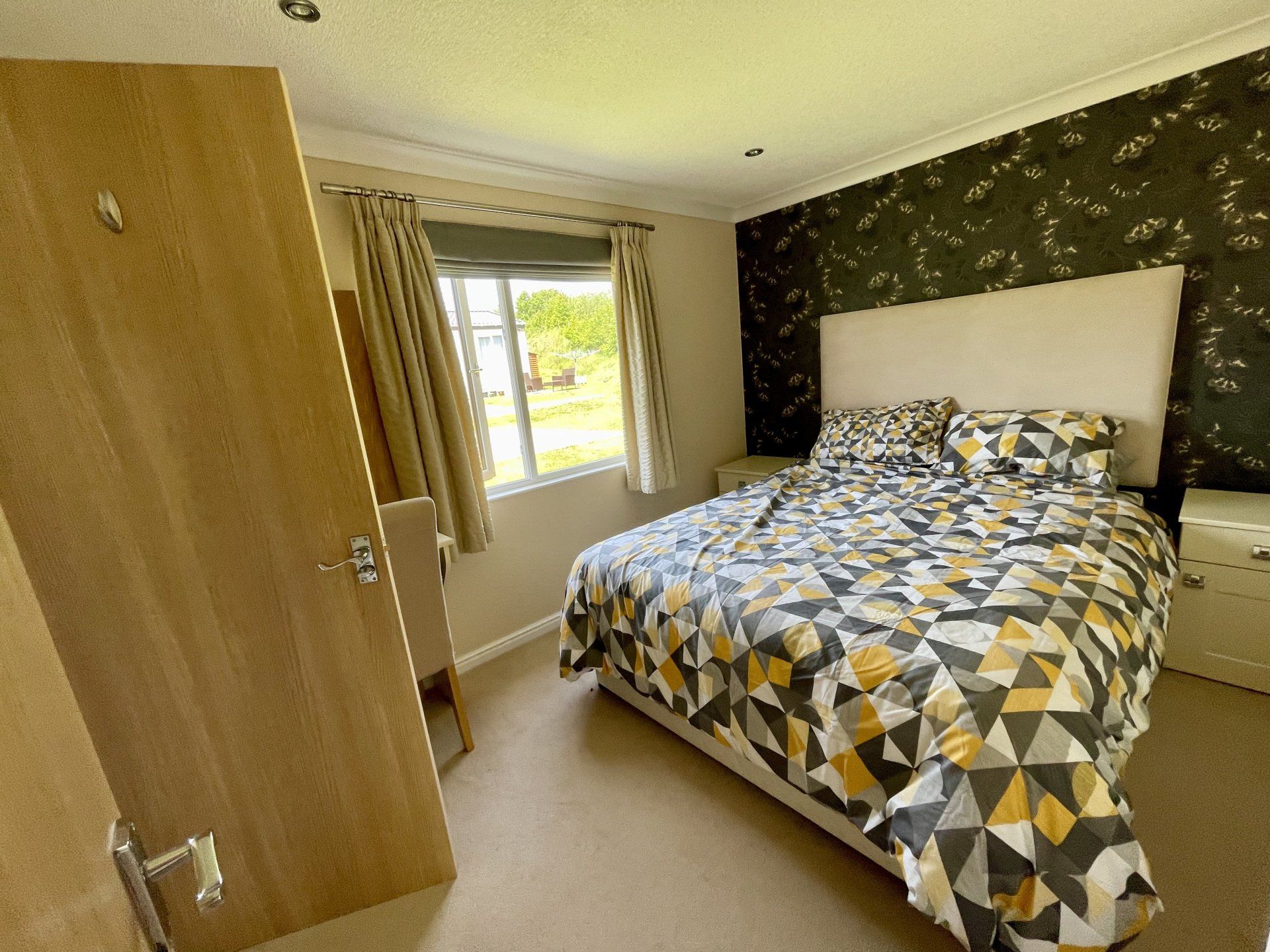 A bedroom with a large bed and a window.