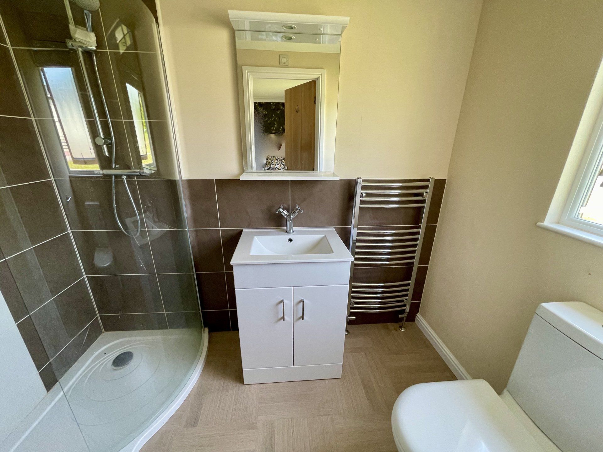 A bathroom with a toilet a sink and a shower