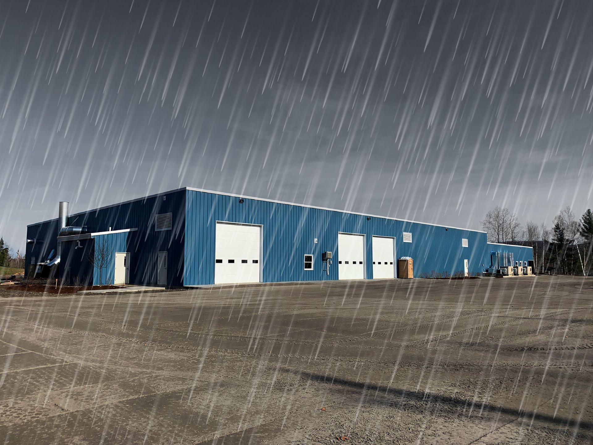 A blue building with white doors is covered in rain.