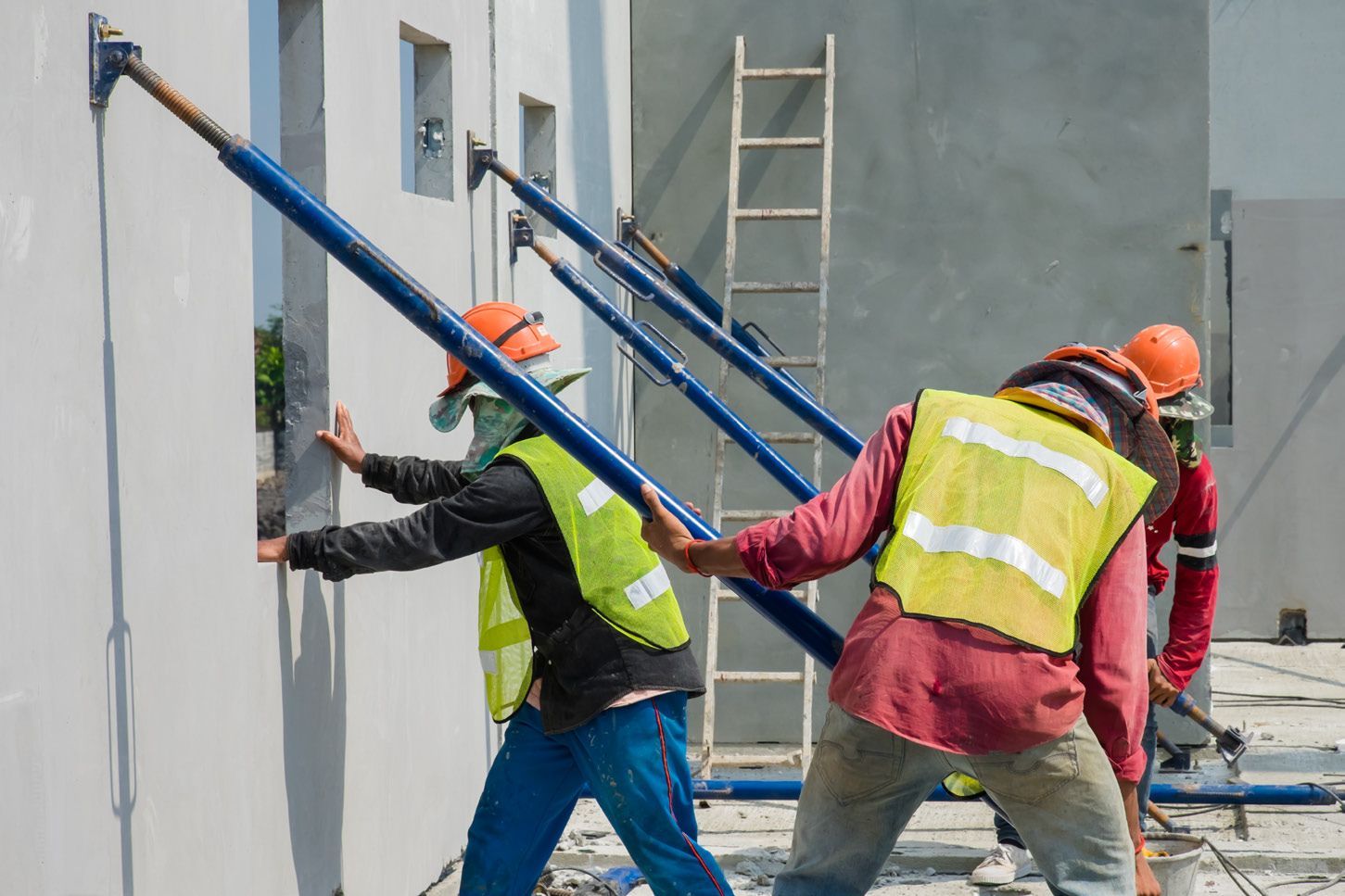 A group of construction workers are working on a building.