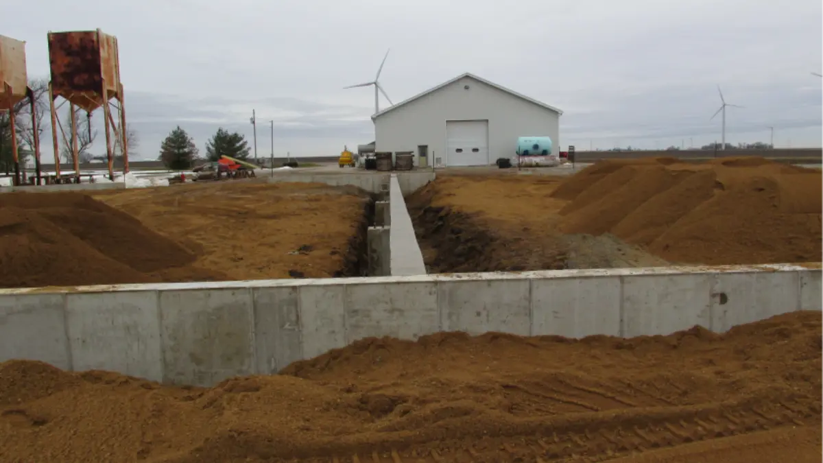 A construction site with a white building in the background