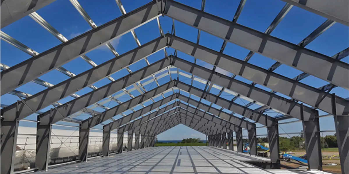 A large building under construction with a blue sky in the background.