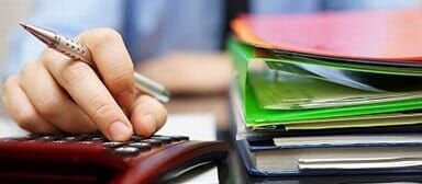Person Calculating Tax Person Calculating Tax