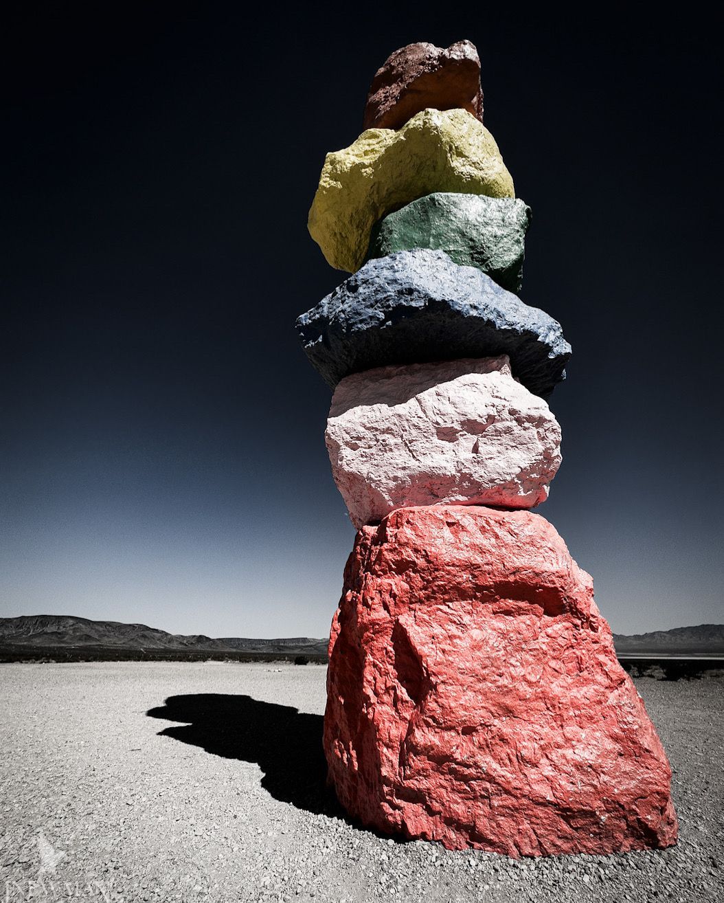 Seven Magic Mountains art installation in Nevada. Large, colorful stacked boulders on a desert road.
