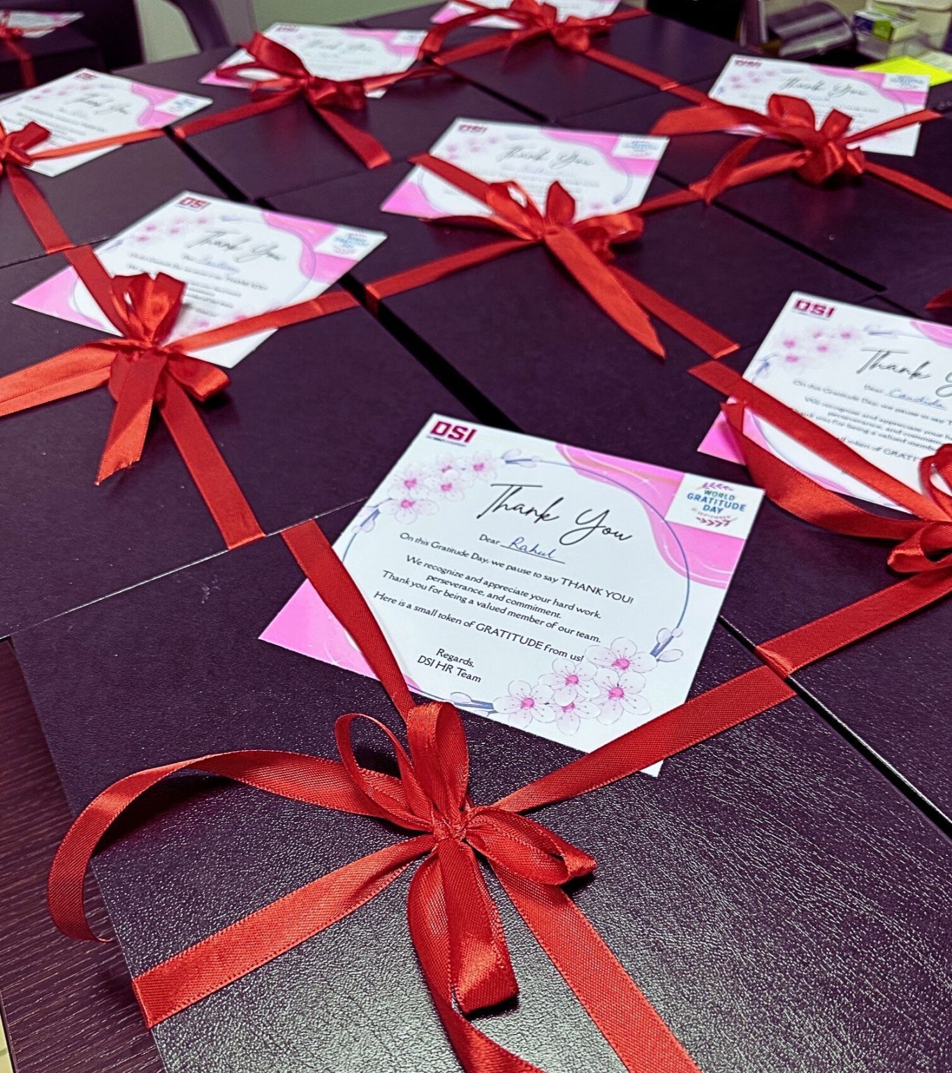 Several black gift boxes with red bows and 