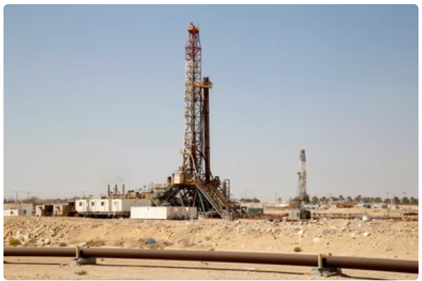 A large oil rig in the middle of a desert