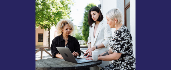 Picture of 3 women looking at a website on a computer