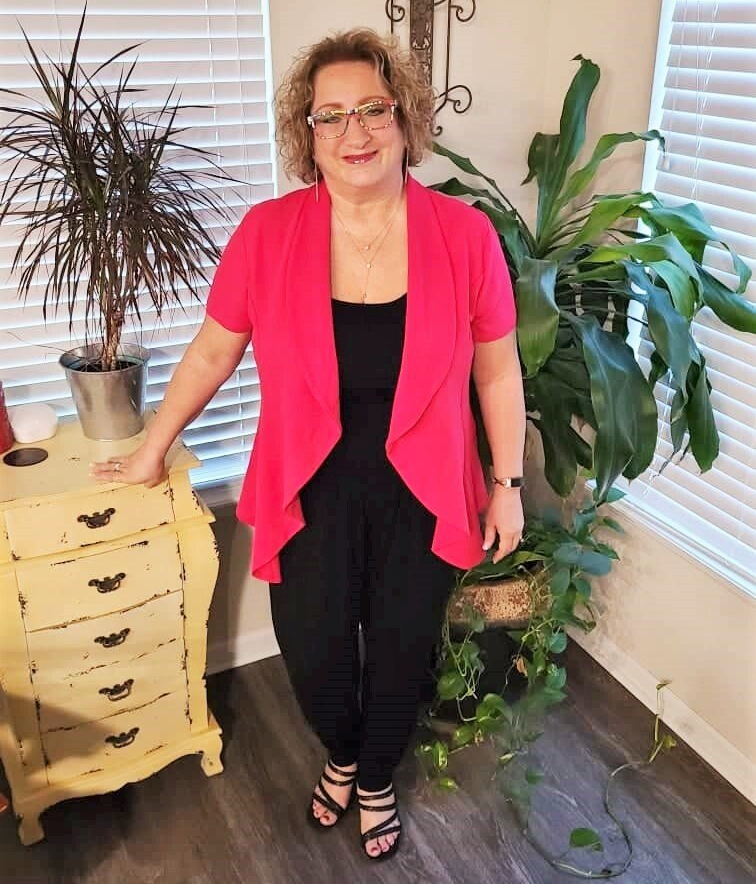 image of Lori dressed for a webinar in a bright pink jacket