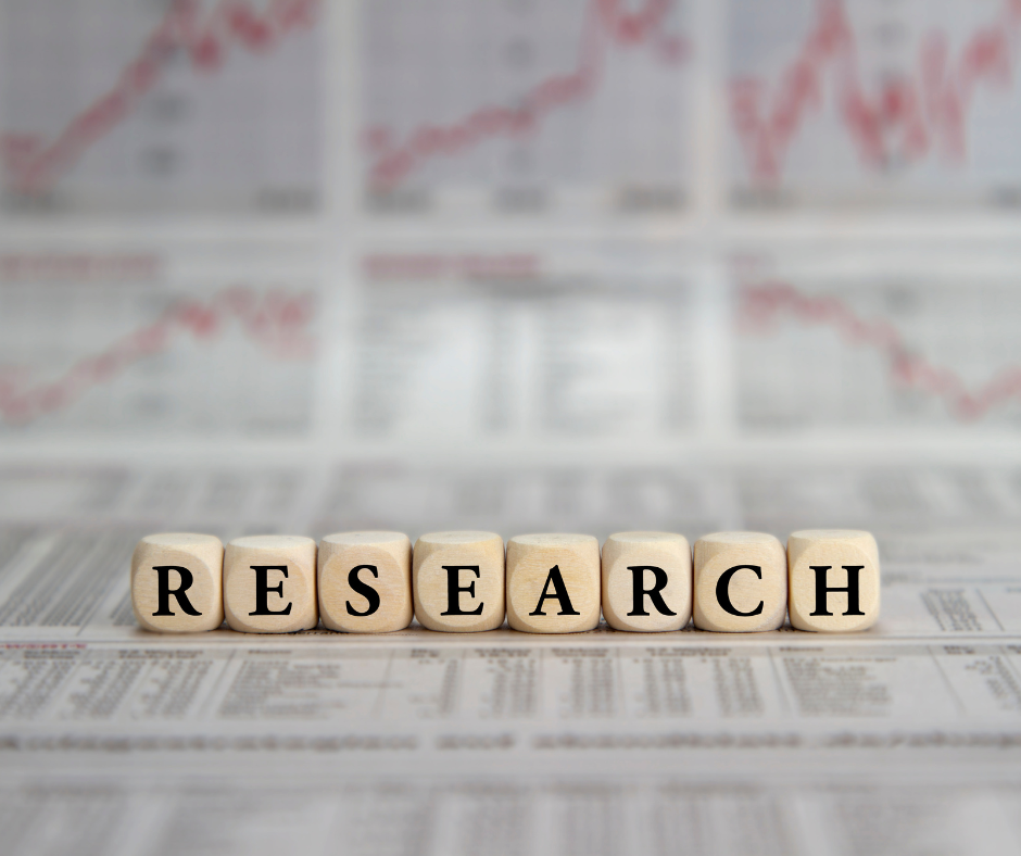 Research spelled out with blocks on a long sheet of paper with data on it
