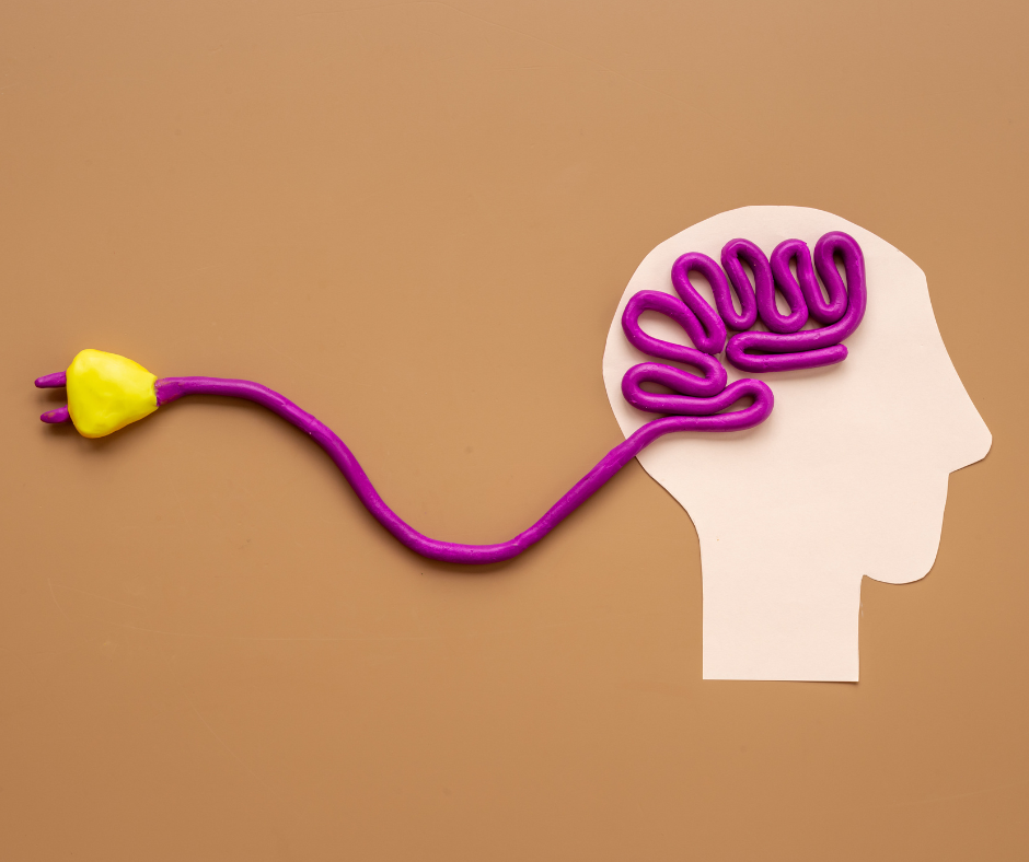 Cut out of head on paper with electric cord coming out of the brain area
