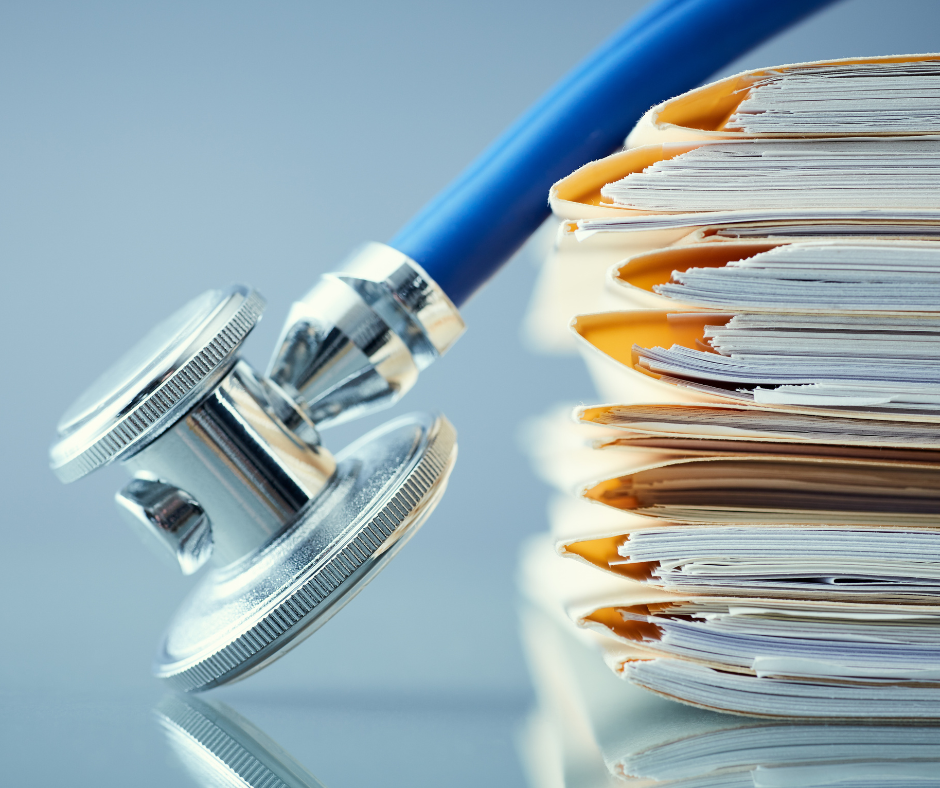 Stack of medical records and a stethoscope. 