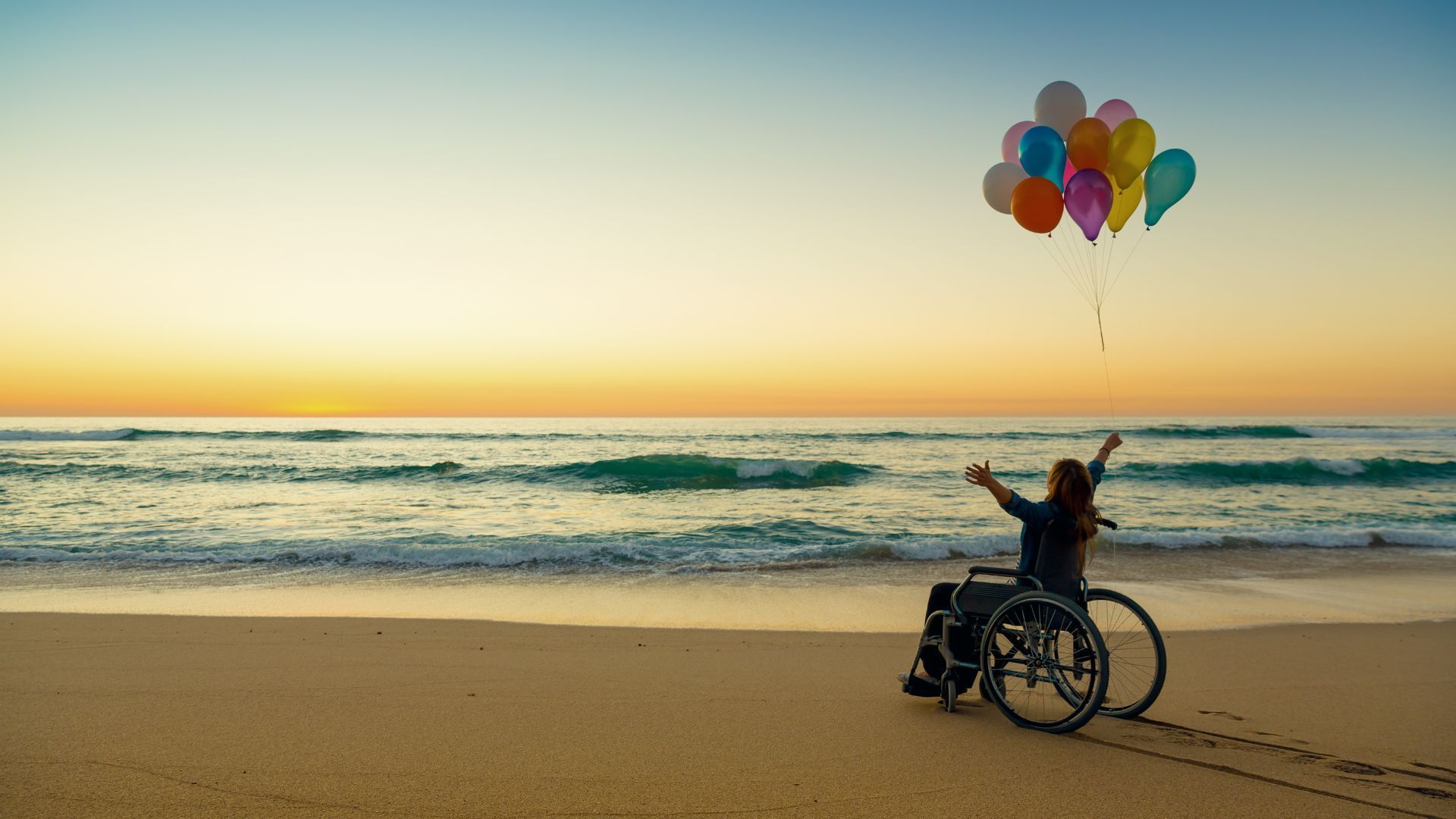 Rainbow figures representing diversity, including a wheelchair user, with a black background.