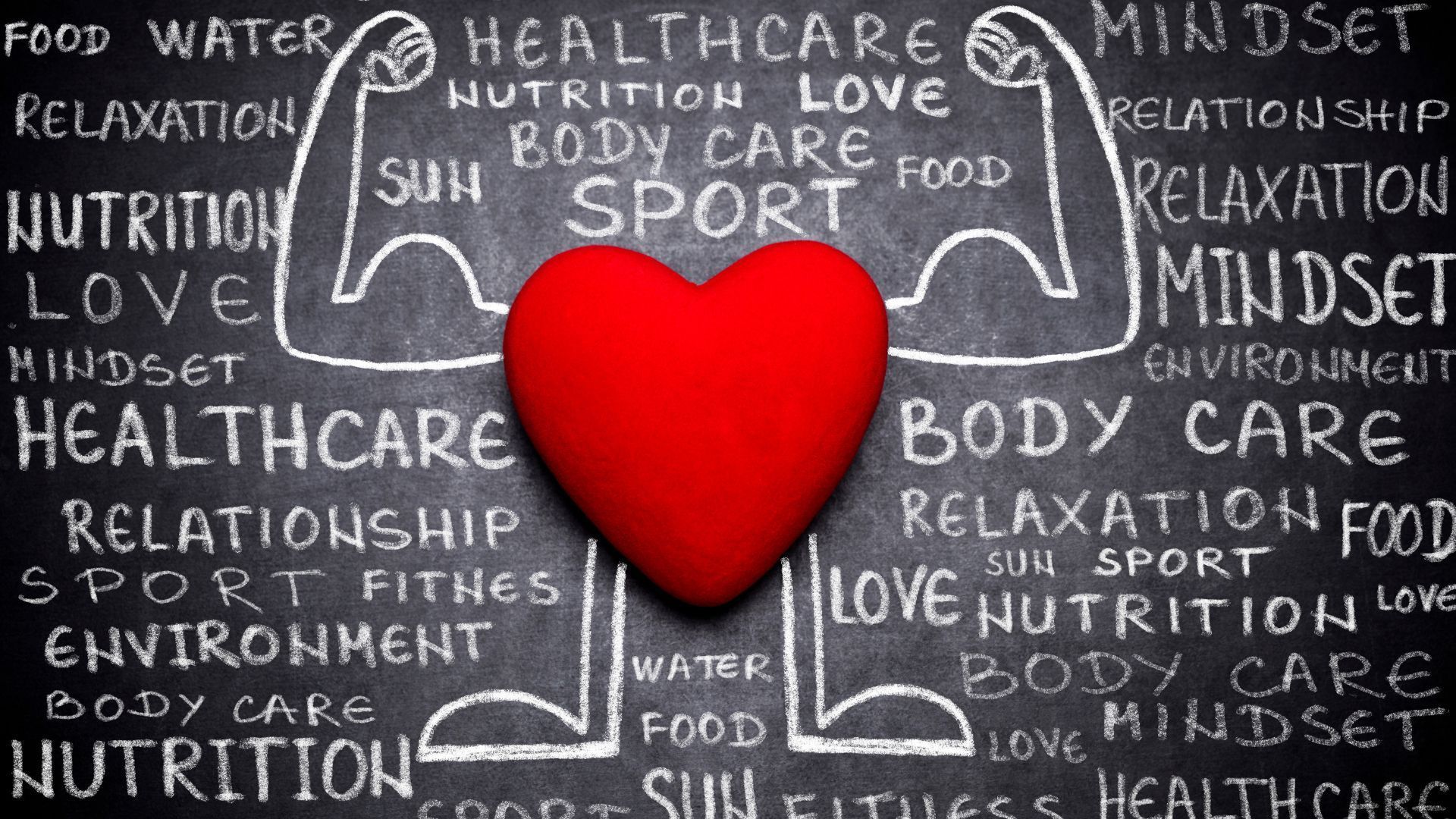 Red heart centered on a chalkboard with words like