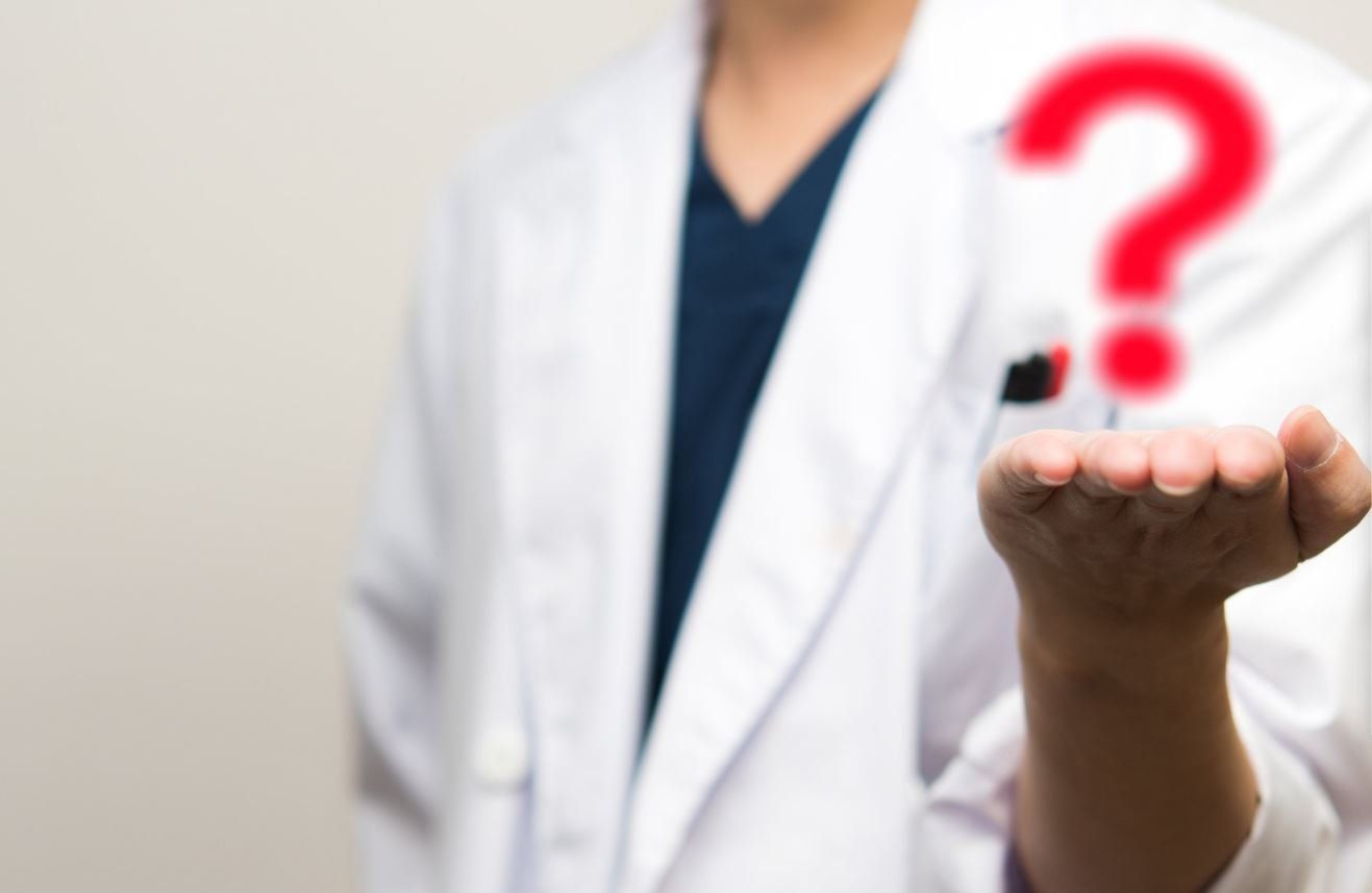 A medical professional in a white coat with an outstretched hand beneath a floating red question mark, symbolizing the uncertainty and ongoing search for diagnosis in mystery patient cases