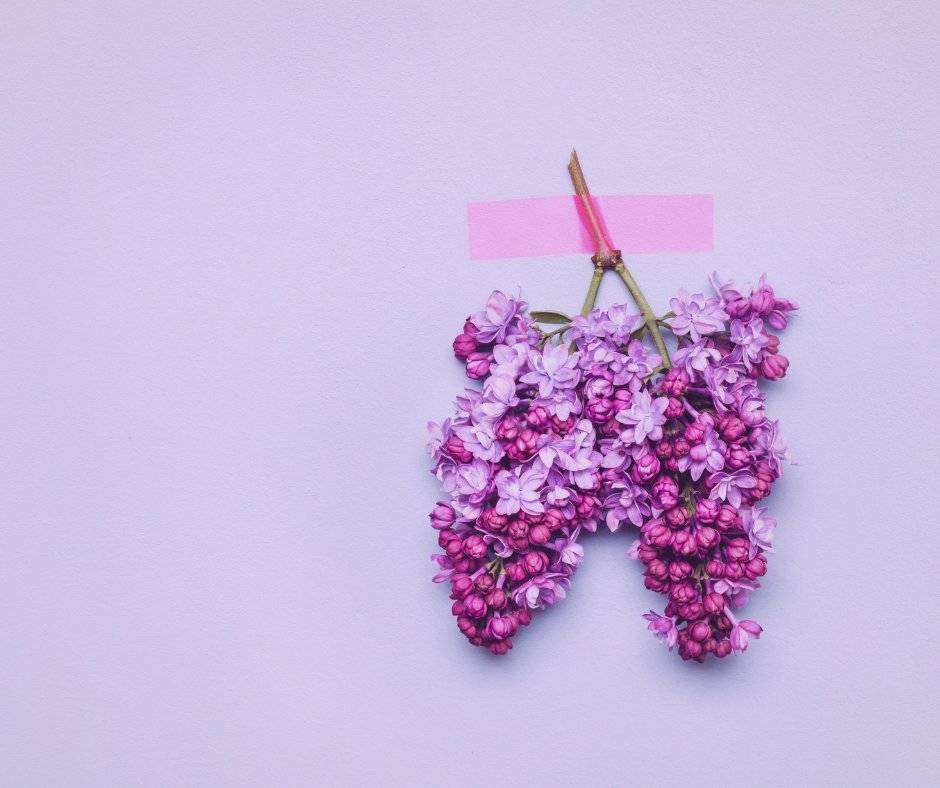 Purple flowers shaped like lungs taped to a purple wall