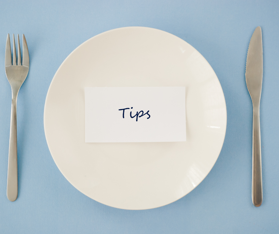 Empty plate with fork and knife and a piece of paper that says