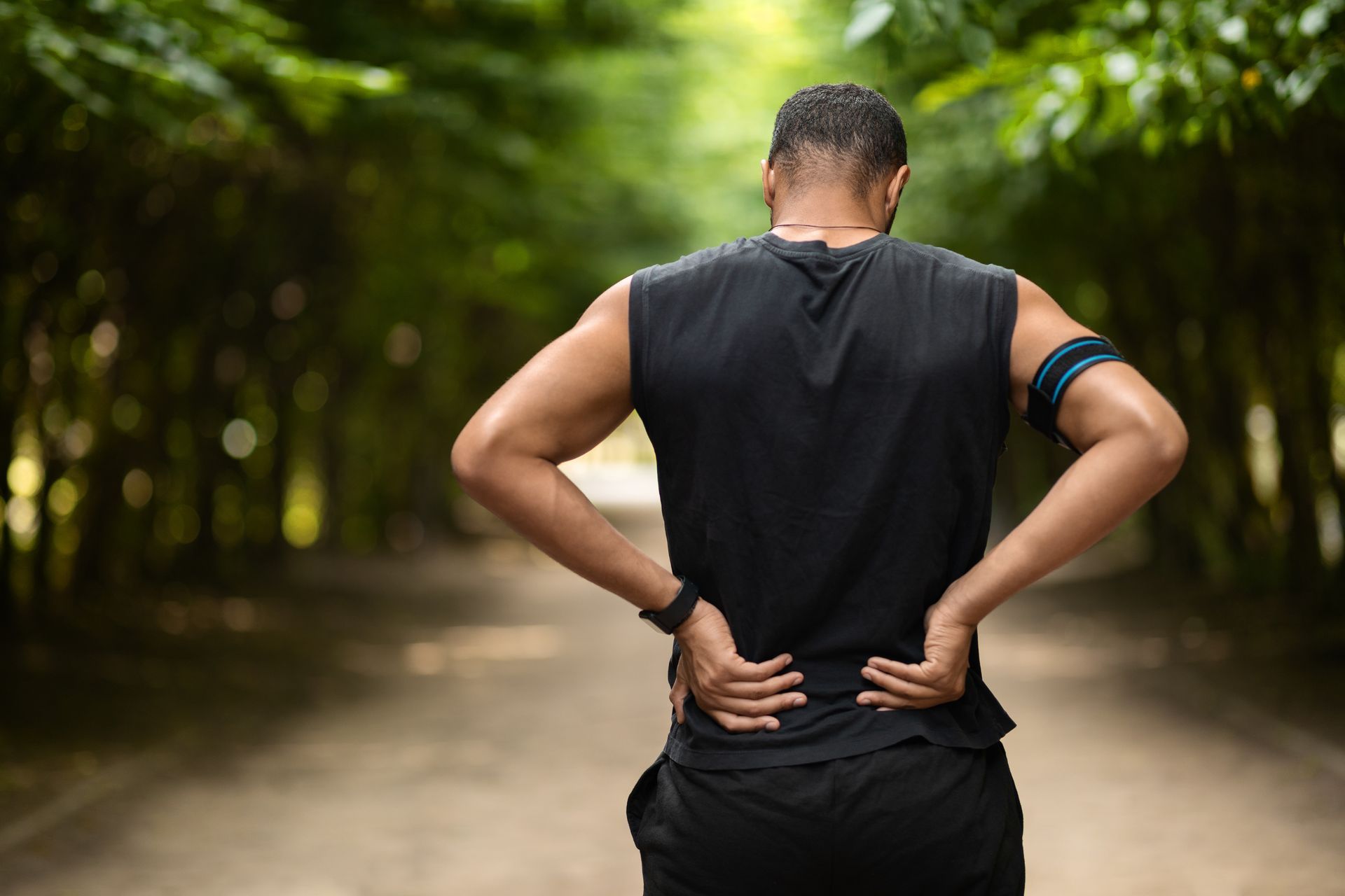 Person experiencing discomfort highlighting need for chronic back pain treatment and relief.