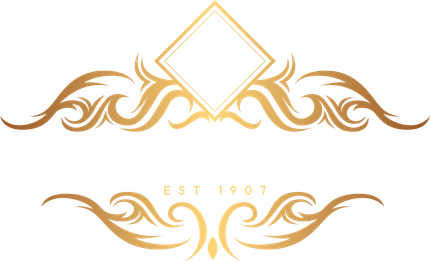 Logo for Kungl Funeral Home, featuring a gold decorative border, the letter K, and the text "EST 1907".