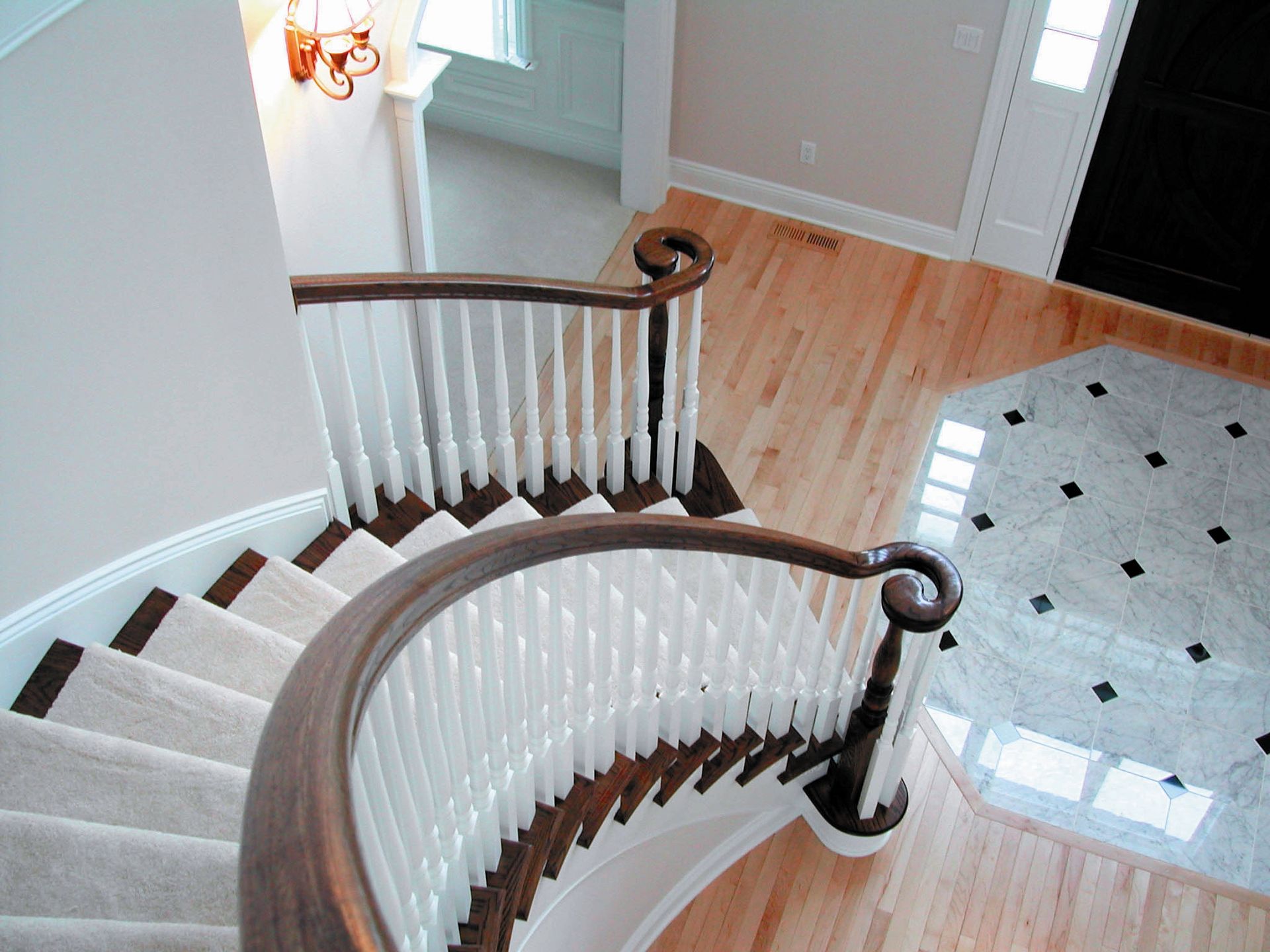 An aerial view of a curved staircase in a house.