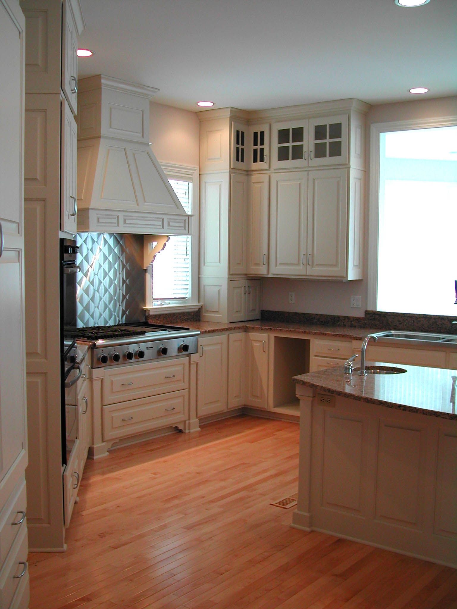 A kitchen with white cabinets and stainless steel appliances