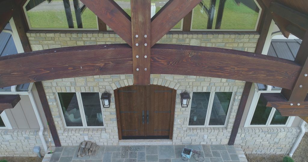 An aerial view of a house with a wooden roof and a wooden door.