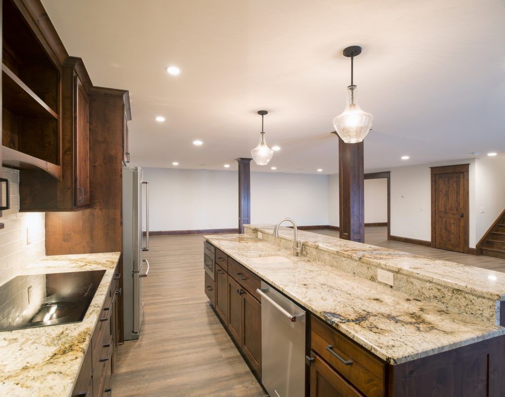 A kitchen with granite counter tops and stainless steel appliances.