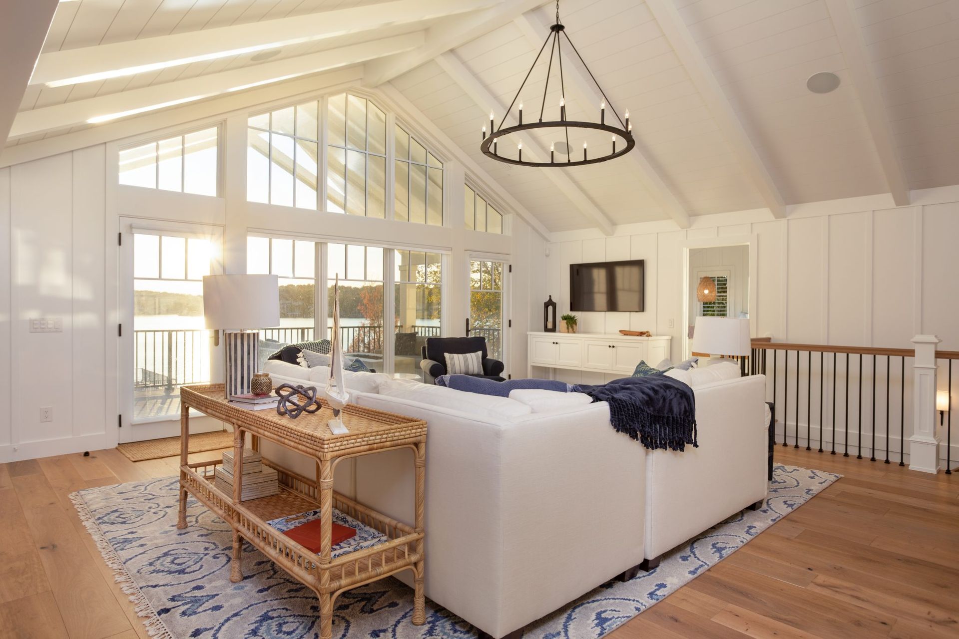 A living room with a large white couch and a chandelier.